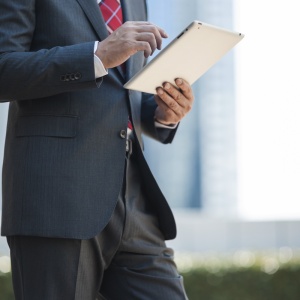 Businessman in suit using tablet in city Businessman in suit using tablet in city