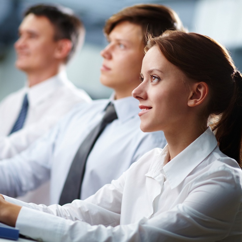 Smiling businesswoman listening in corporate meeting Smiling businesswoman listening in corporate meeting