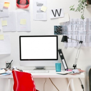 Home office desk with computer and skateboard