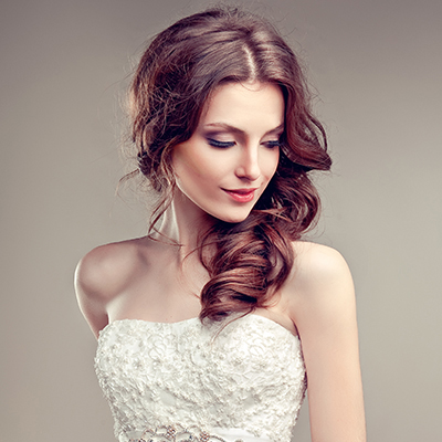Woman in white lace dress with curled hair