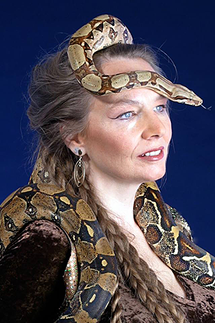 A Portrait of Serpentessa with a boa constrictor wrapped about her with it's head rising behind her and crowning her head
