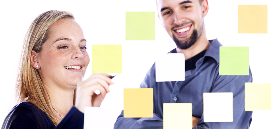 Two colleagues collaborating with sticky notes